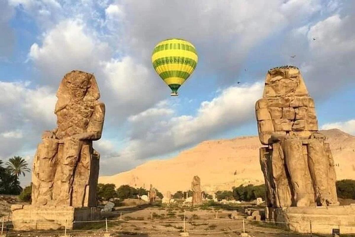 a hot air balloon flying over the ancient temples