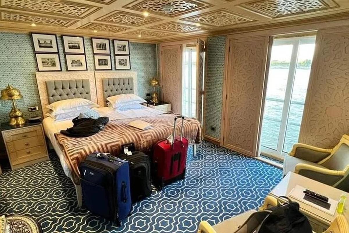 a hotel room with a bed with luggage in it