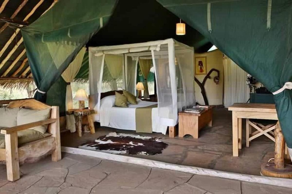 a bedroom with a canopy bed in a tent