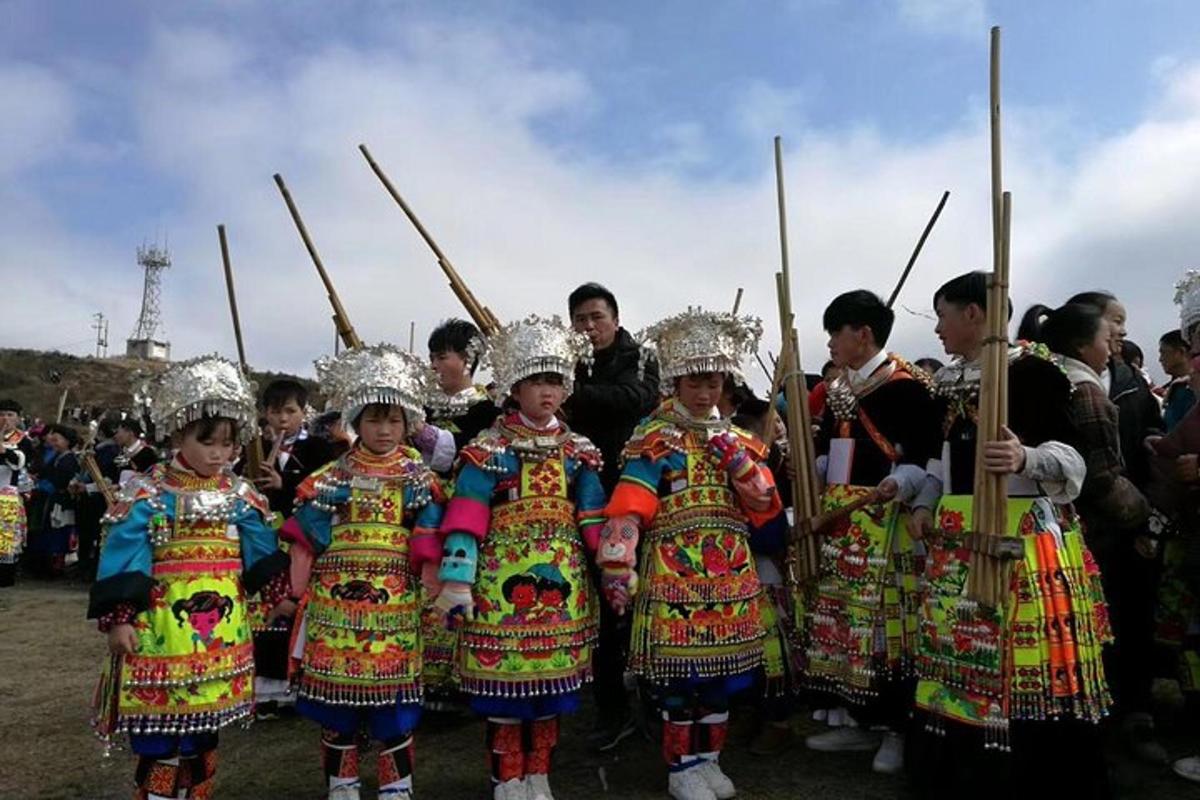 a group of children in traditional costumes with spears