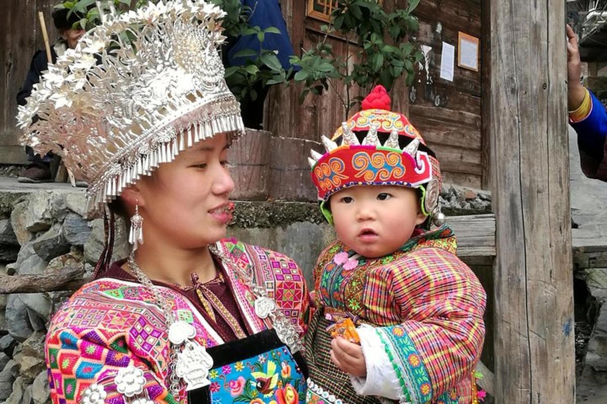 a woman holding a baby wearing a crown