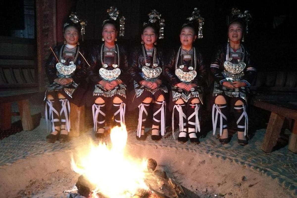 a group of children sitting around a fire