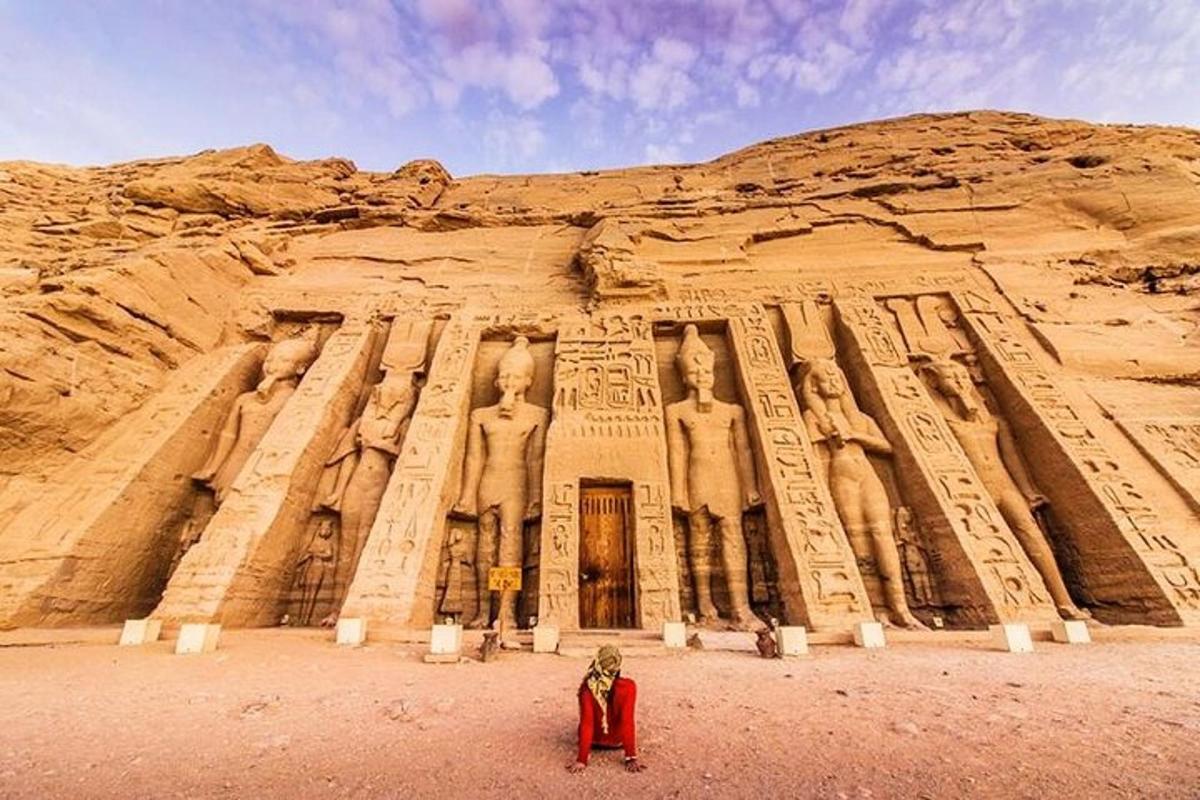 a person standing in front of an ancient building