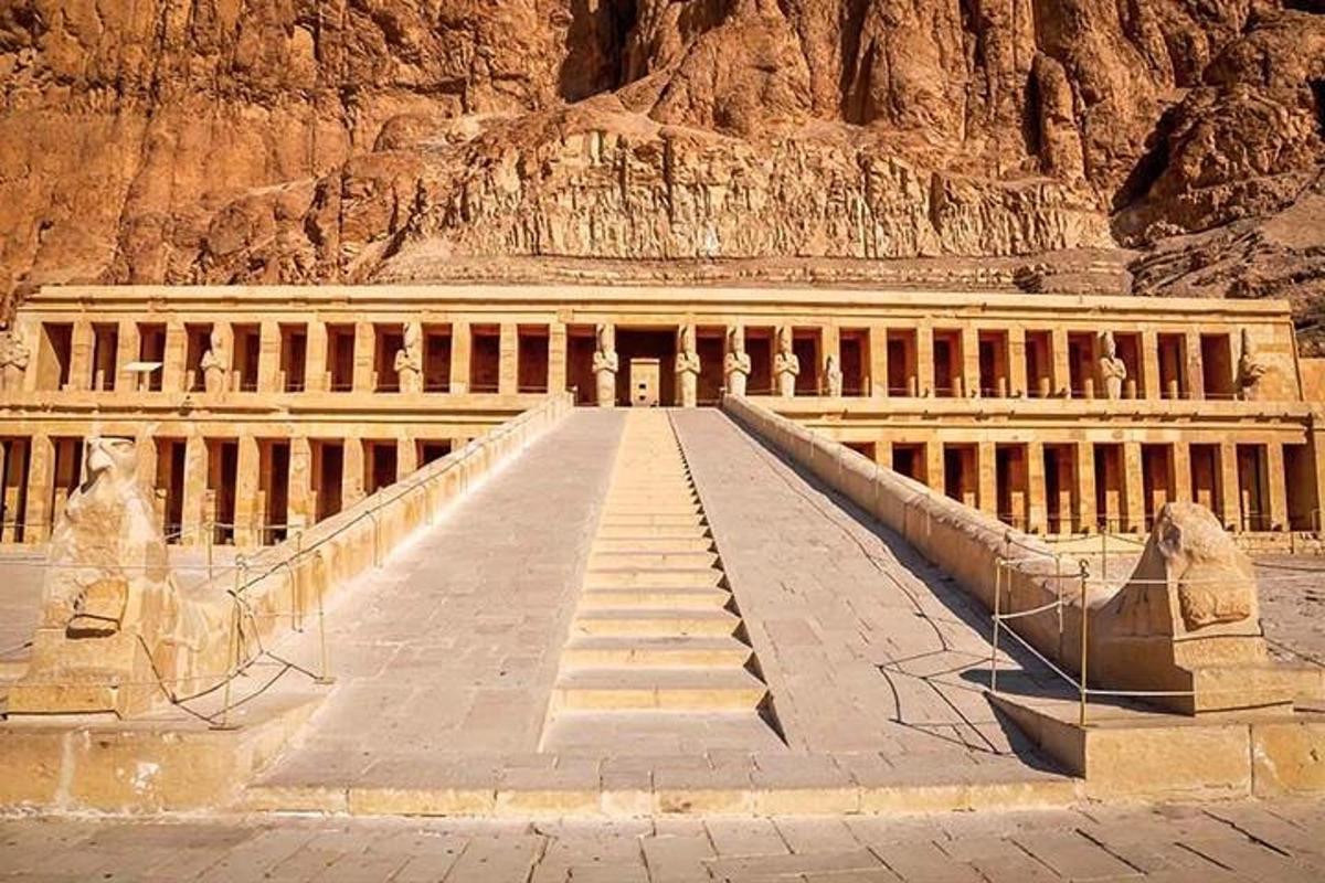 a staircase leading to a building in front of a mountain