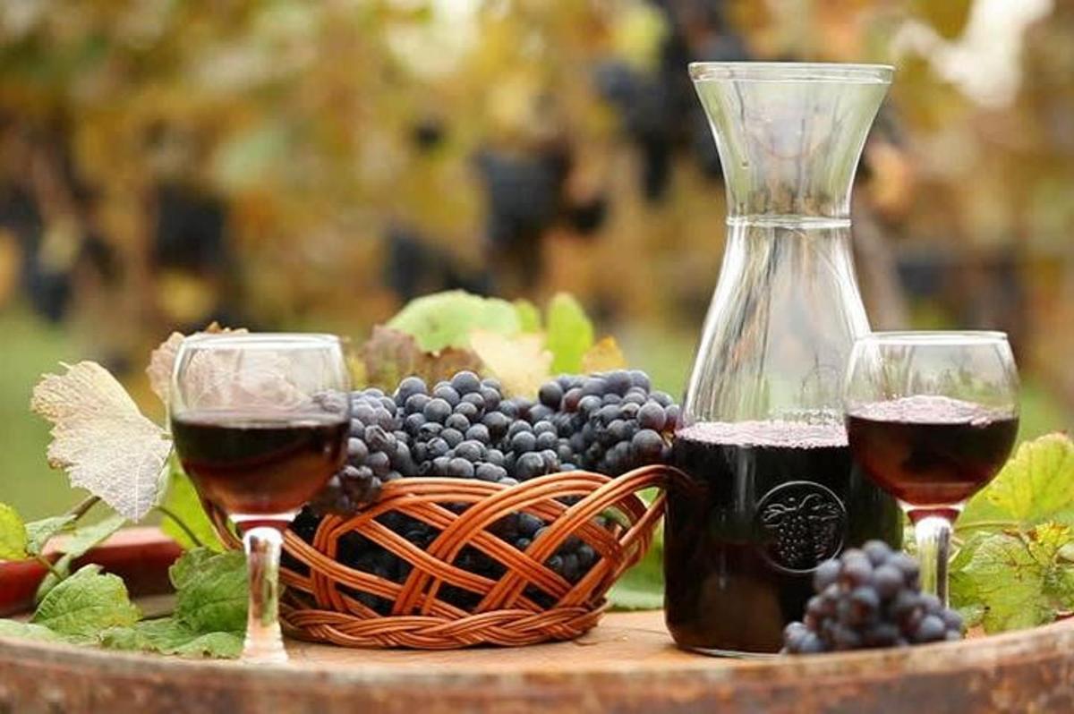 due bicchieri di vino e un cesto d'uva