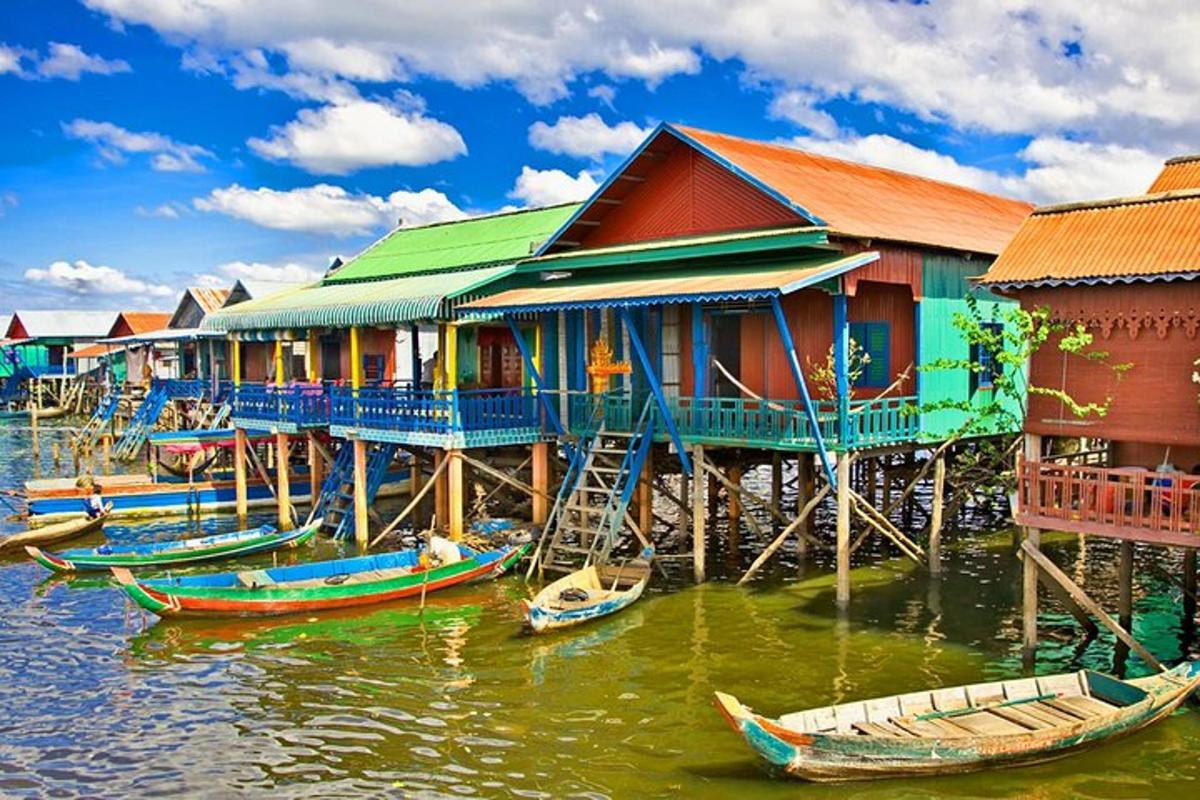 a group of houses on the water with boats