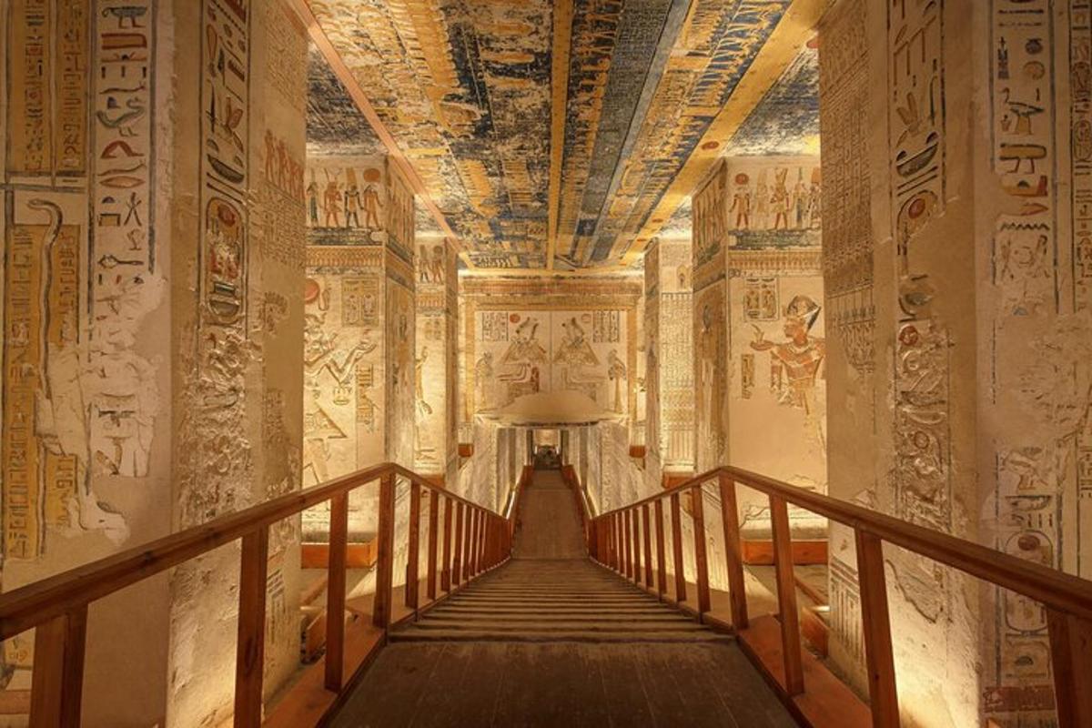 a hallway in an ancient building with paintings on the walls