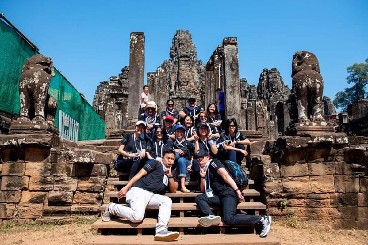 a group of people posing in front of a temple