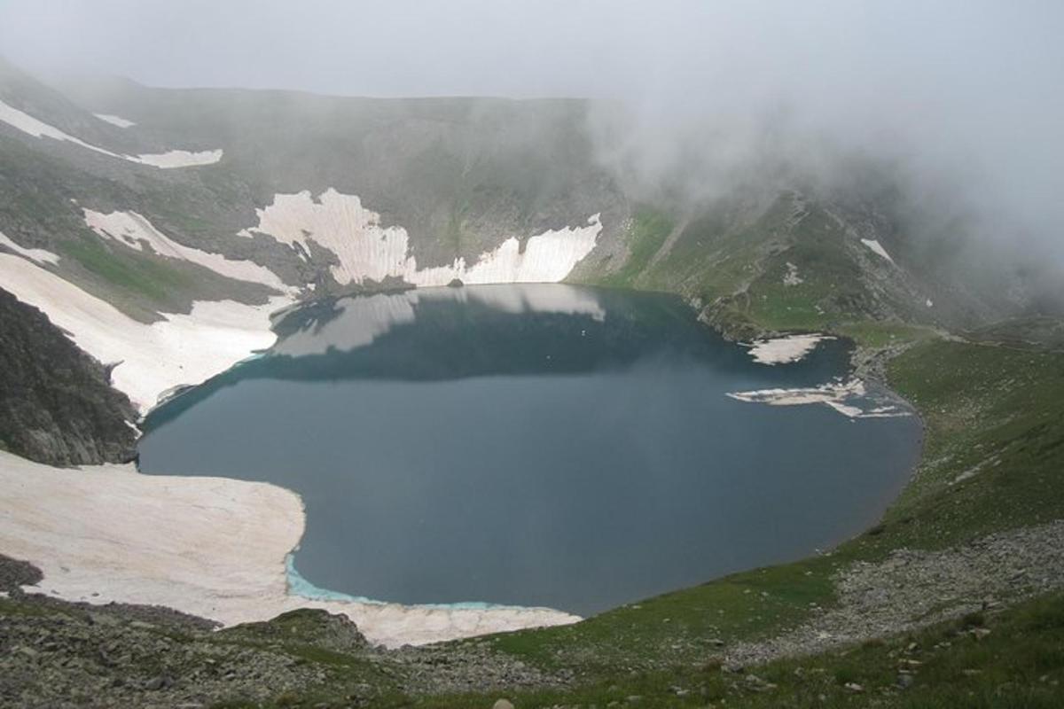 a lake in the middle of a snow covered mountain