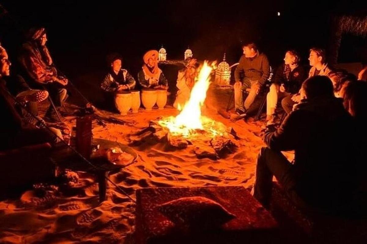 un gruppo di persone sedute attorno a un grande fuoco