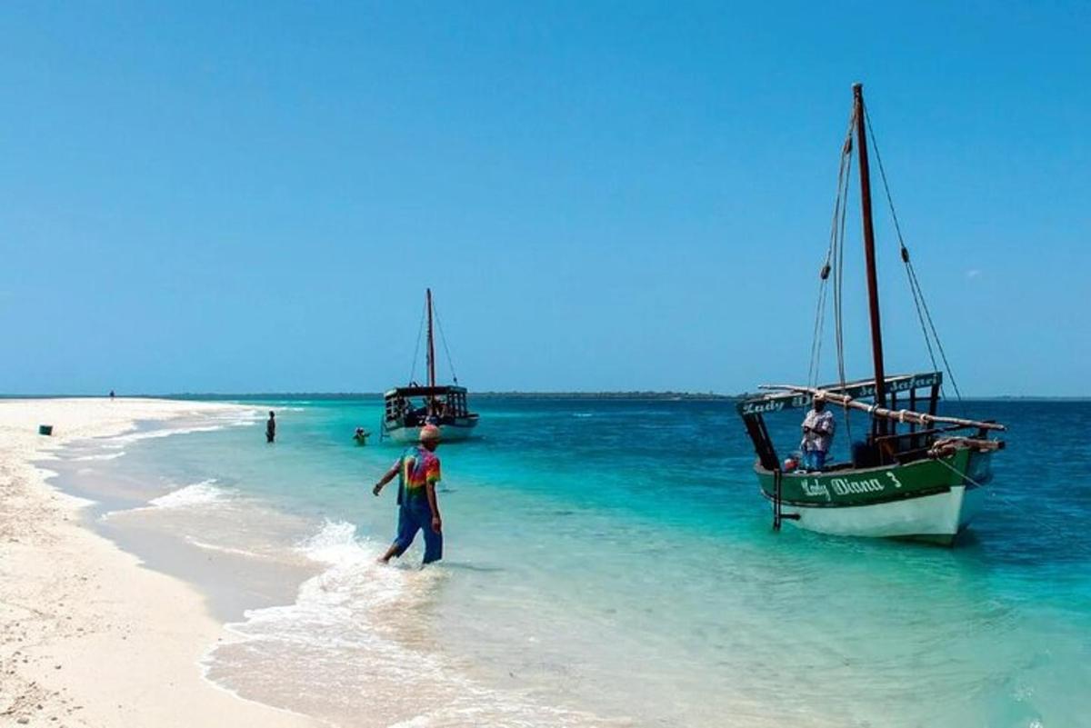 a man walking on the beach next to a boat
