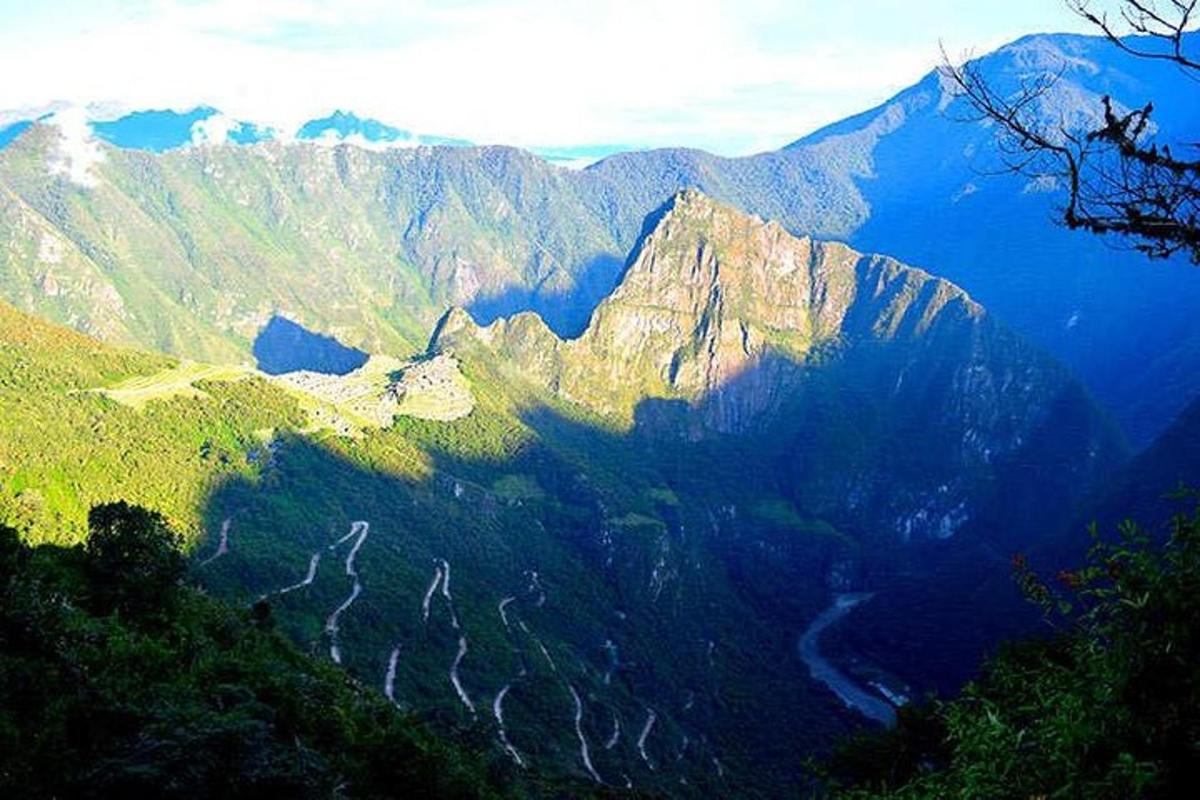 a view of a mountain range with trees and mountains