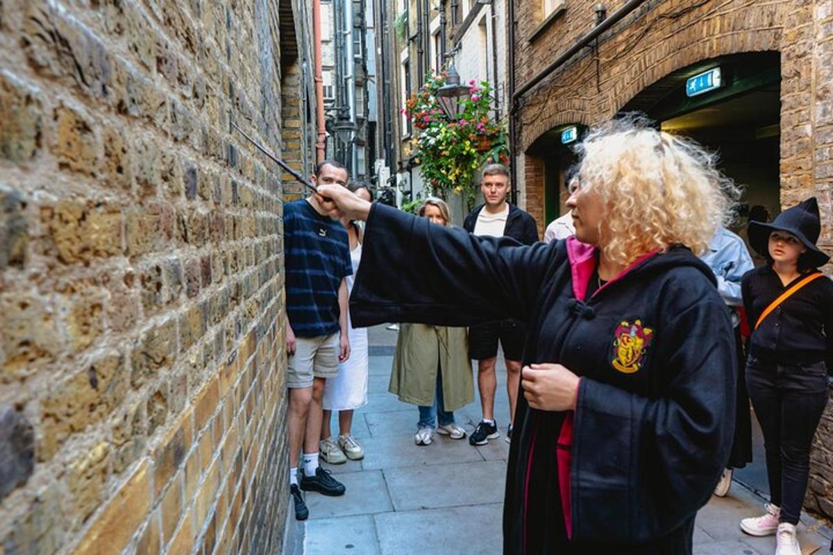 a woman is pointing at a brick wall