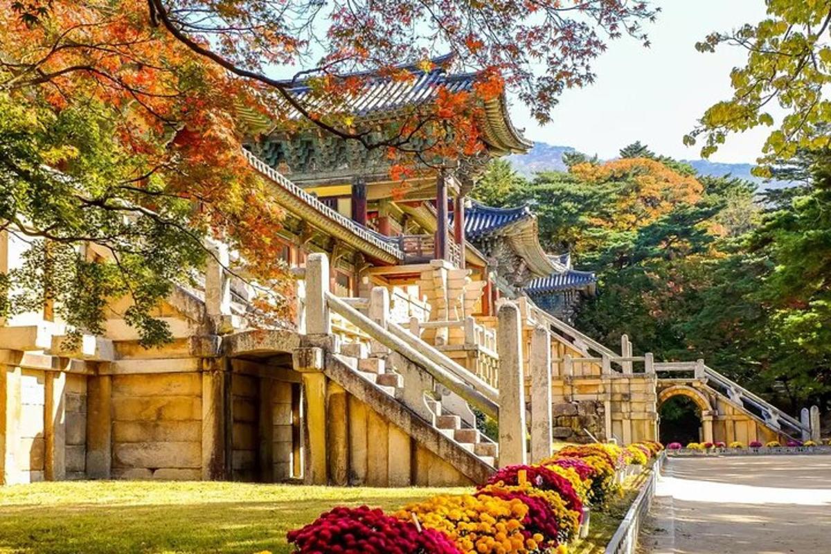 a building with stairs and flowers in front of it