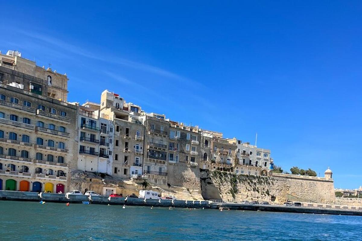 a building on the side of a cliff next to the water