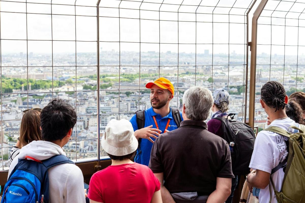a man standing in a crowd of people in a glass tower