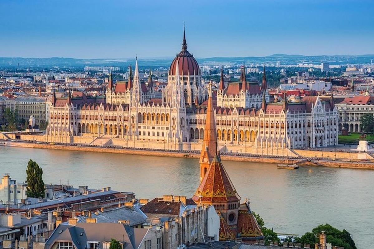 a large building with a tower next to a river