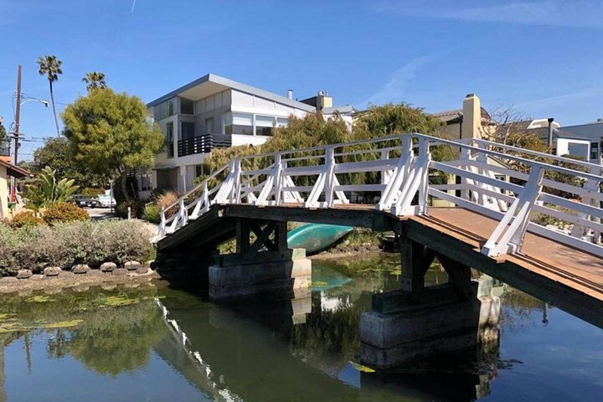 a white bridge over a river in a city