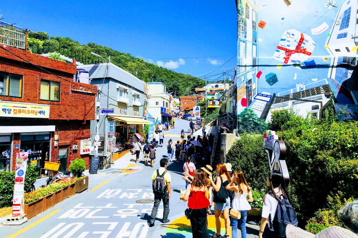 a group of people walking down a city street