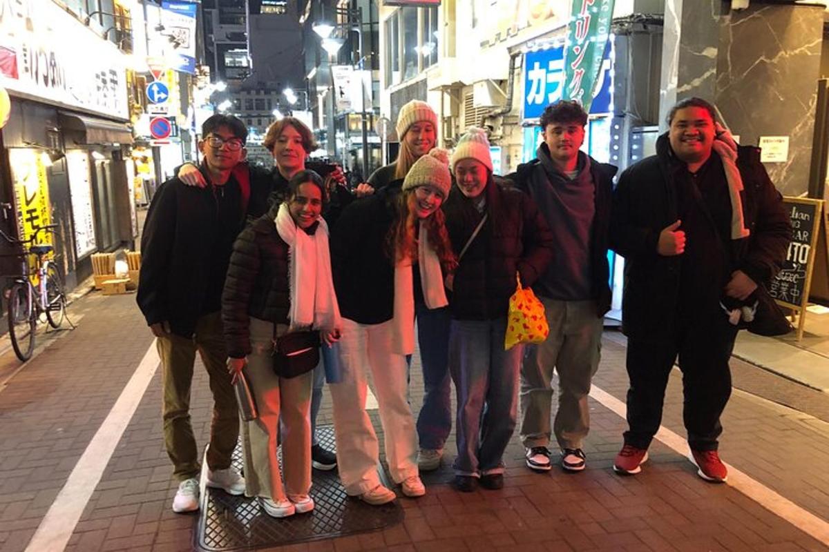 a group of people posing for a picture on a street