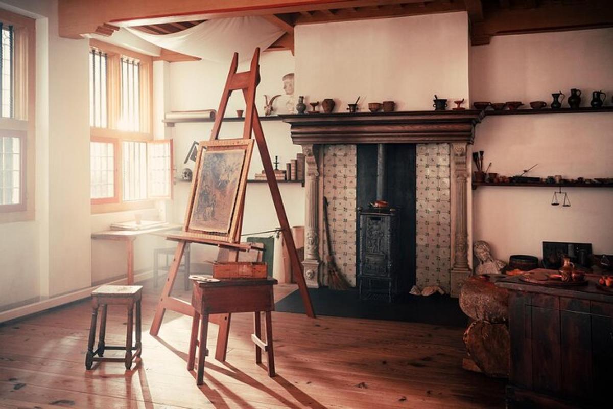 a room with a painting on a ladder and a fireplace