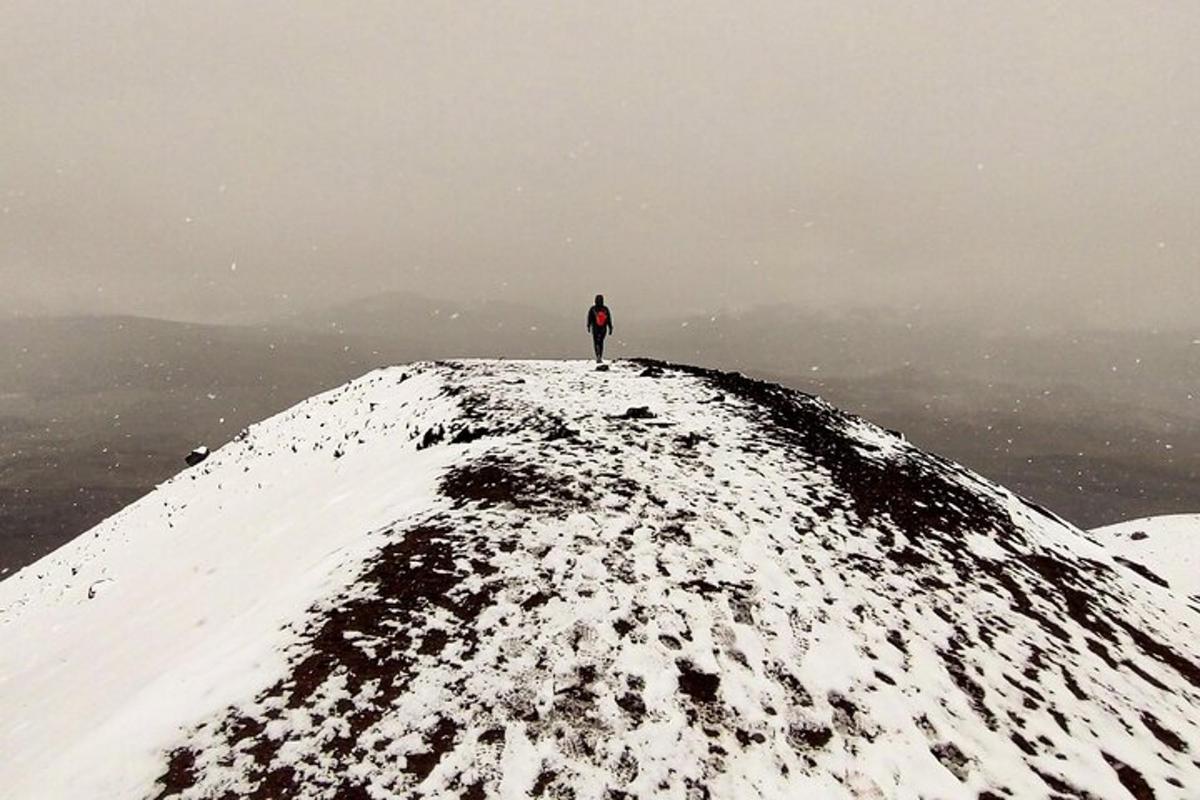 a person standing on top of a snow covered mountain
