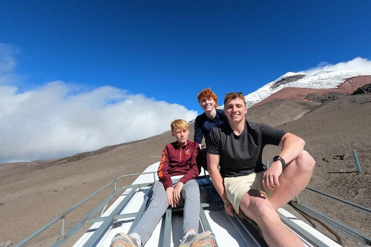a family sitting on the roof of a mountain