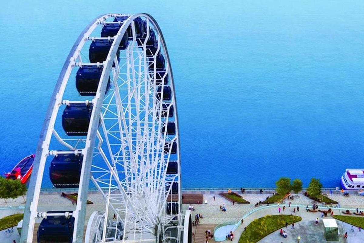 a large ferris wheel in front of the water