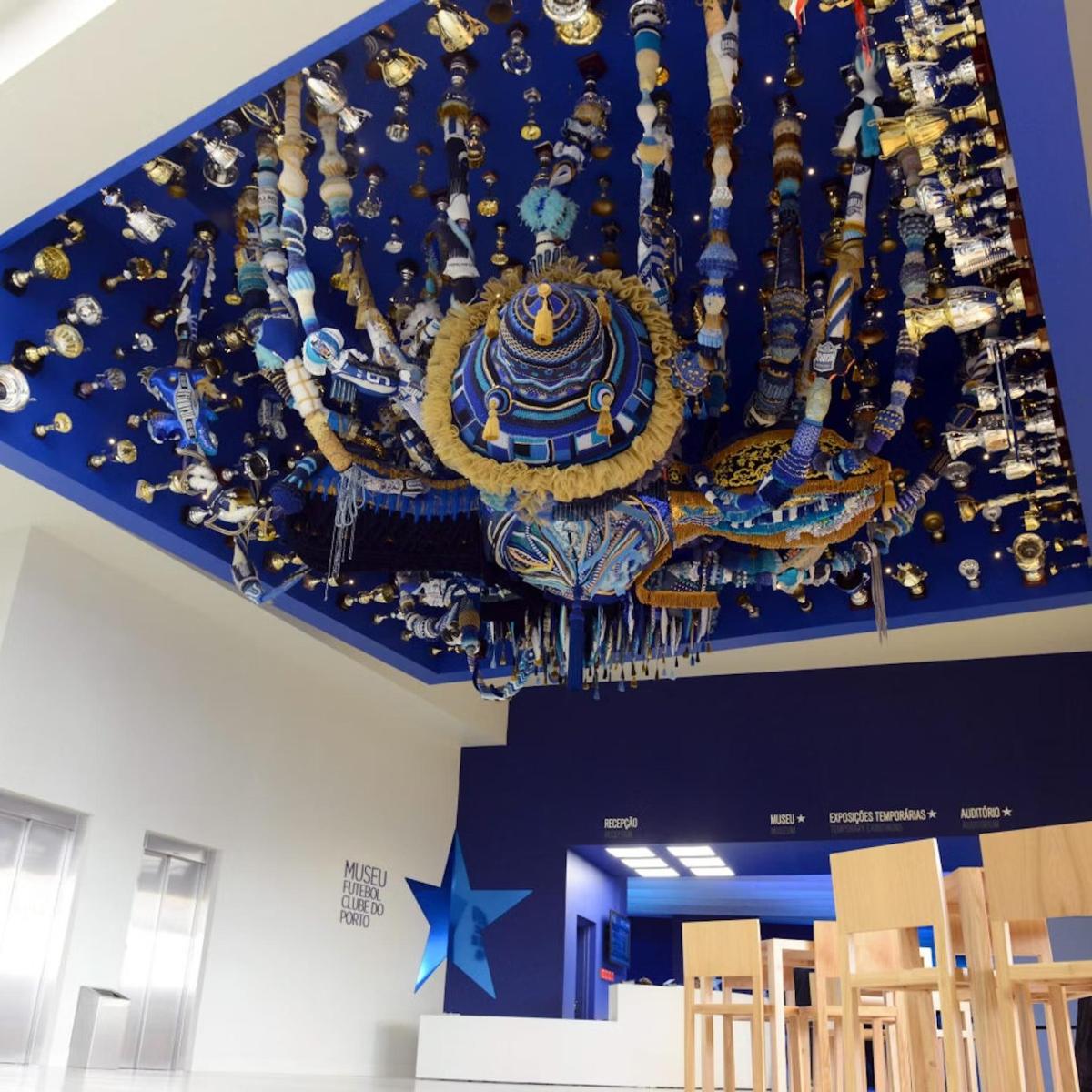a blue and gold chandelier hanging from a ceiling