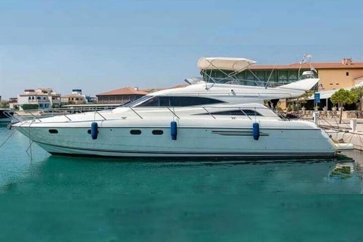 a white boat is docked in the water
