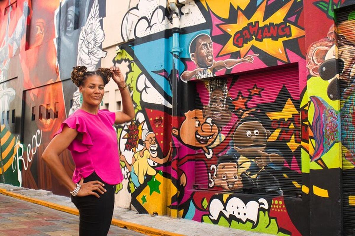 a woman standing in front of a wall with graffiti