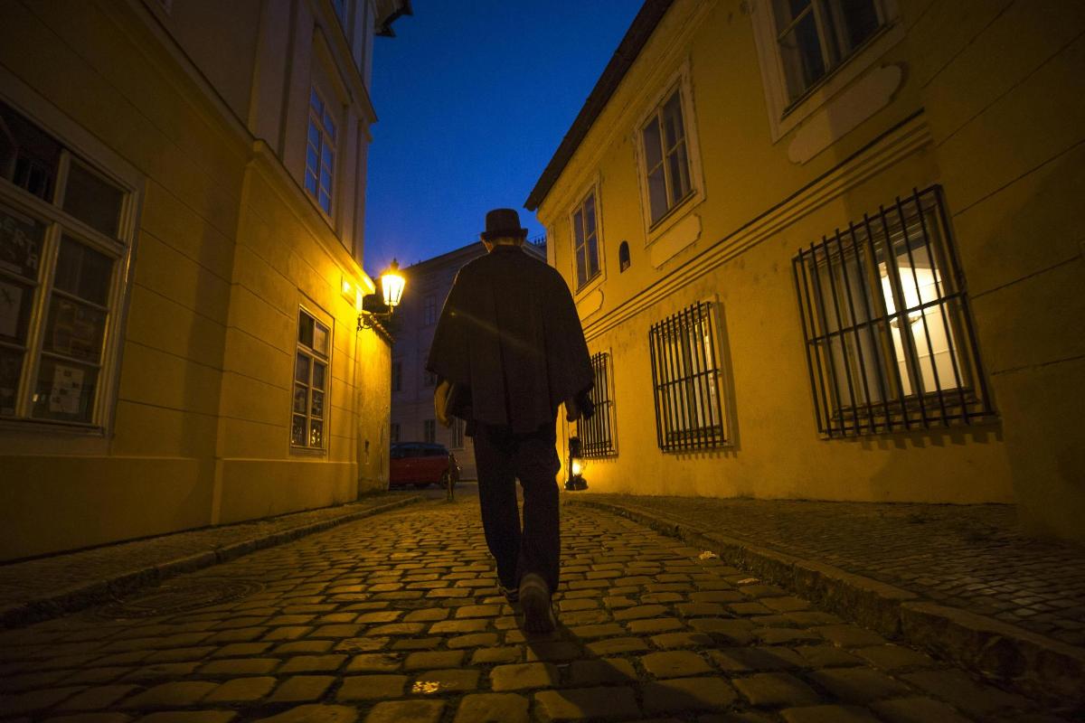 a man walking down a street at night