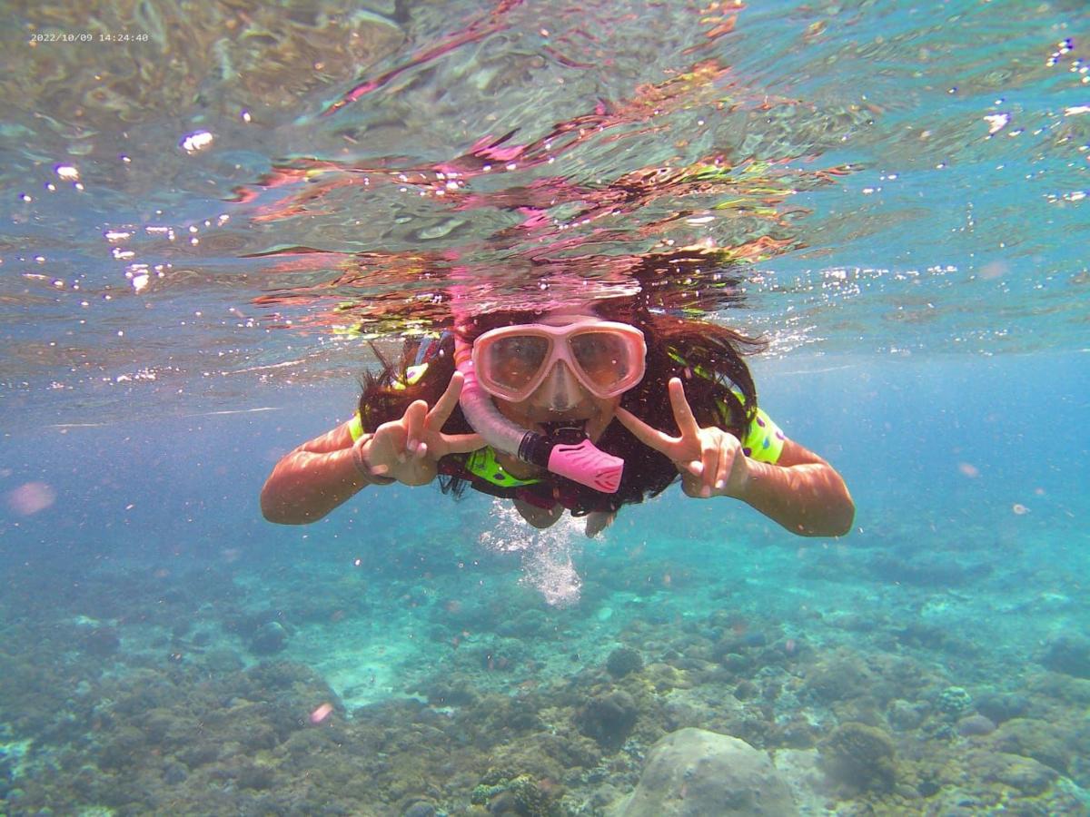 a woman in the water with a snorkel and goggles