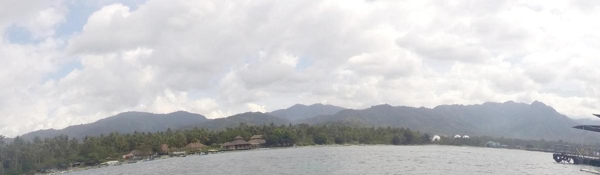 a large body of water with mountains in the background