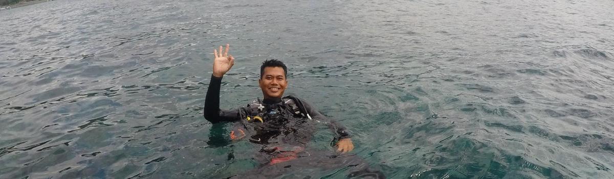a man in the water with his hand in the water
