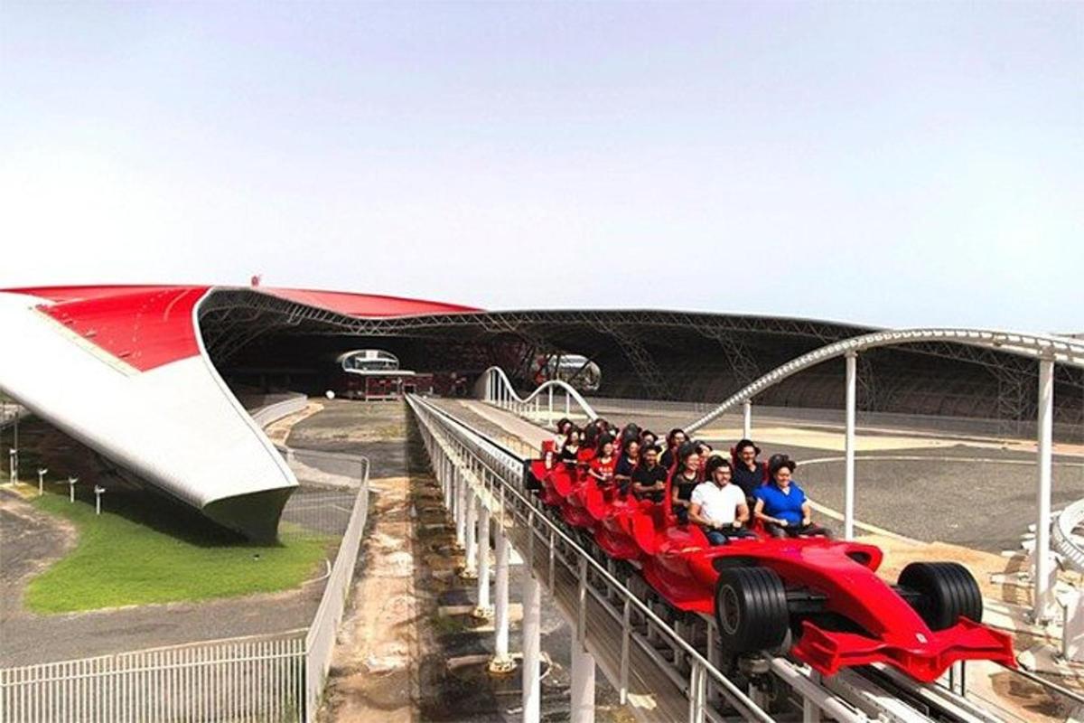 a group of people riding a red car on a roller coaster