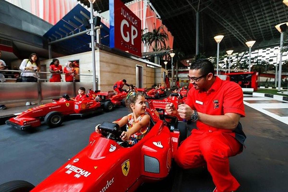 a man and a child sitting in a race car