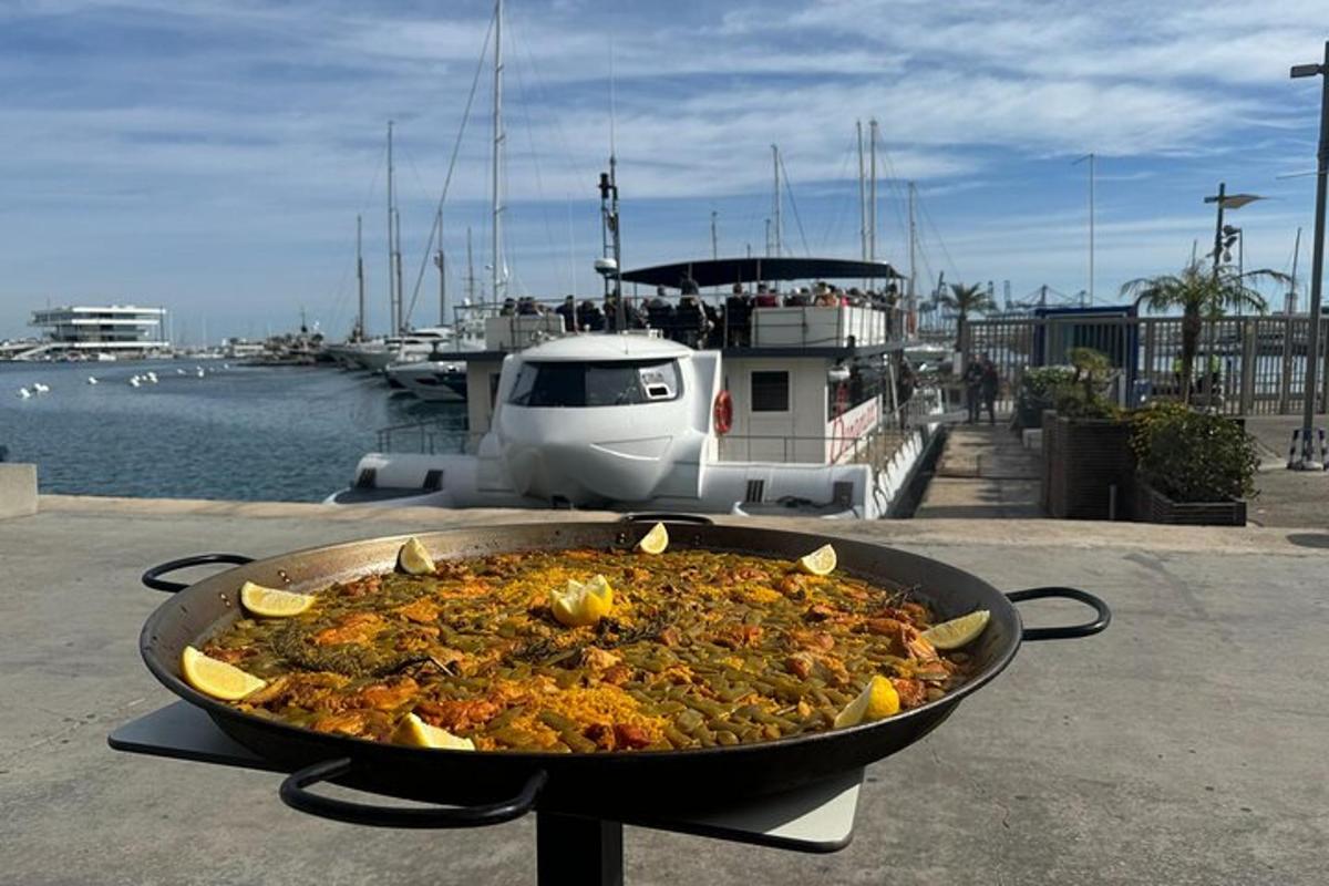 a pan of food on a table next to a boat