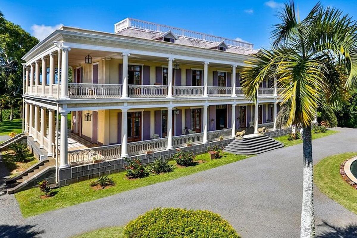 a large house with a palm tree in front of it