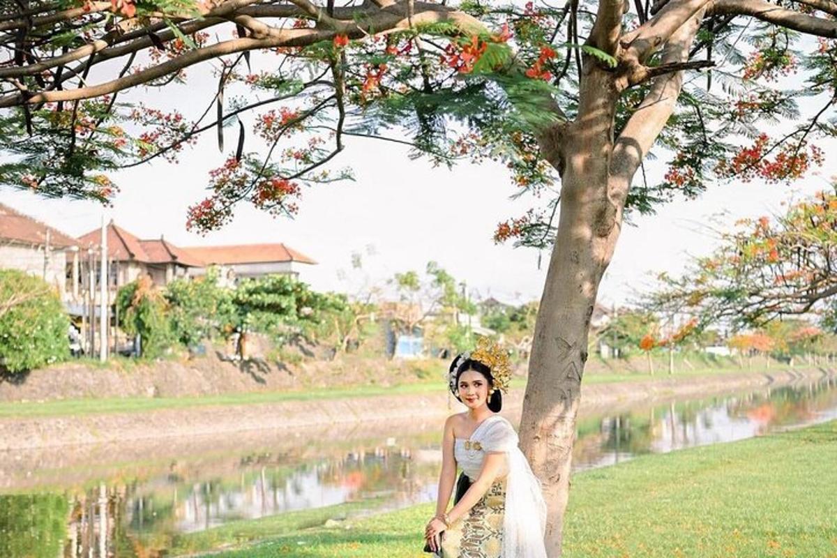 a woman is standing next to a tree