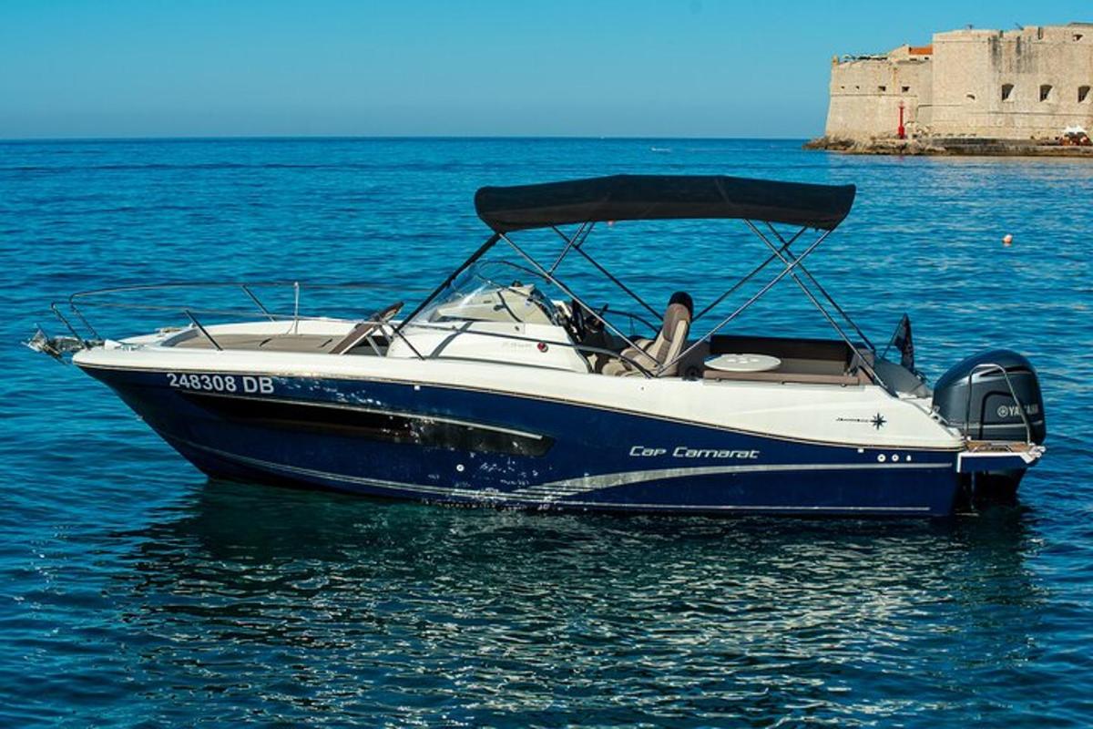 a blue and white boat sitting in the water