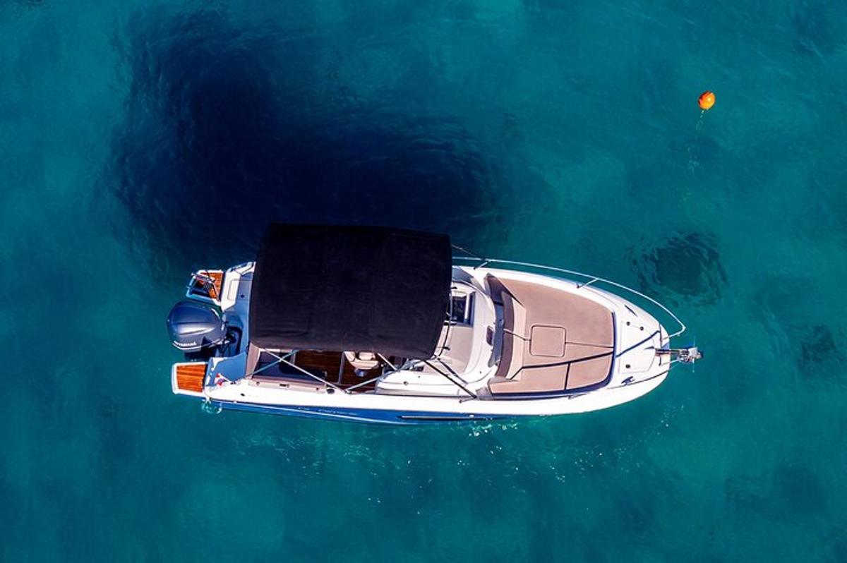 a white boat in the water with a person on it
