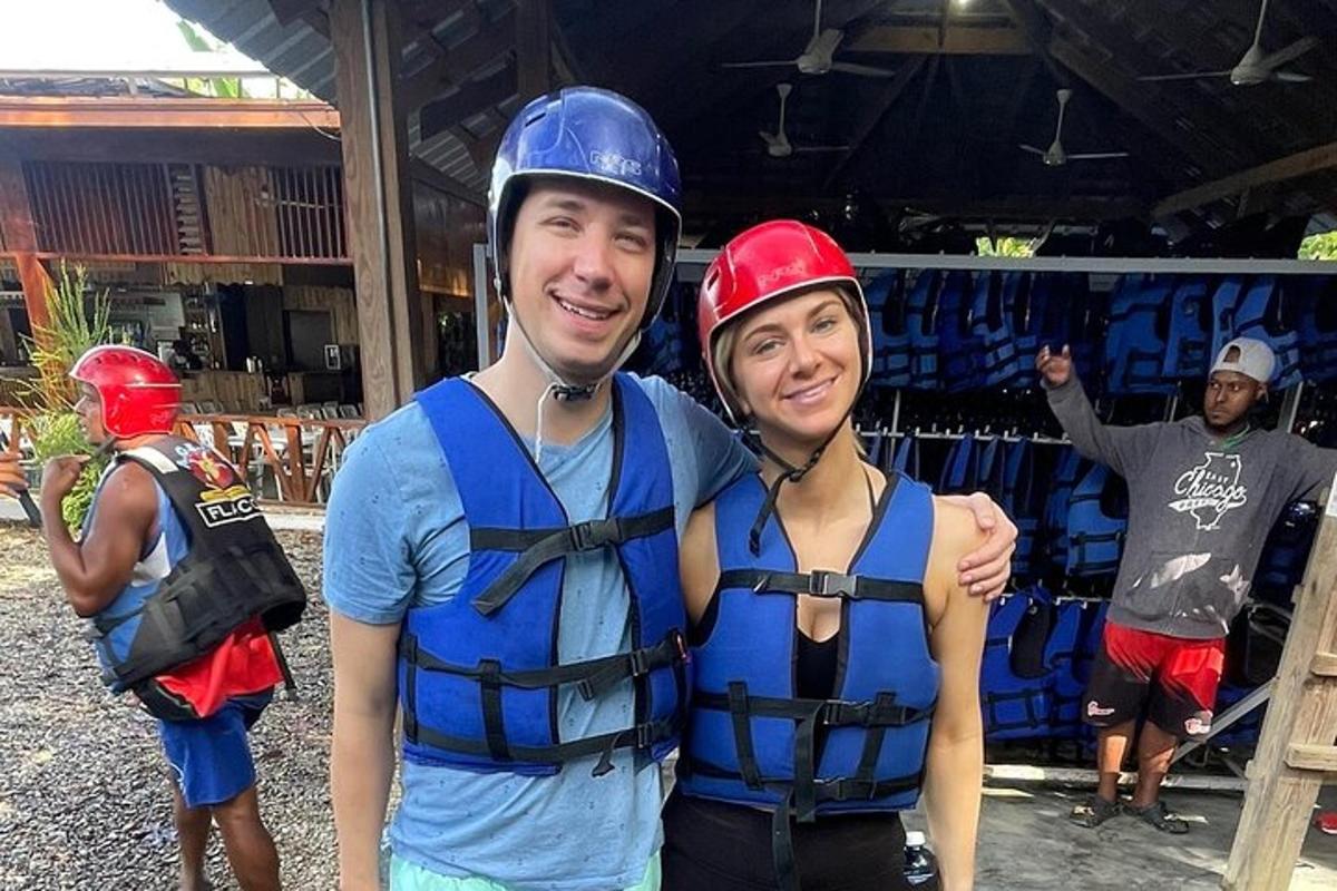 a man and a woman wearing life jackets and helmets