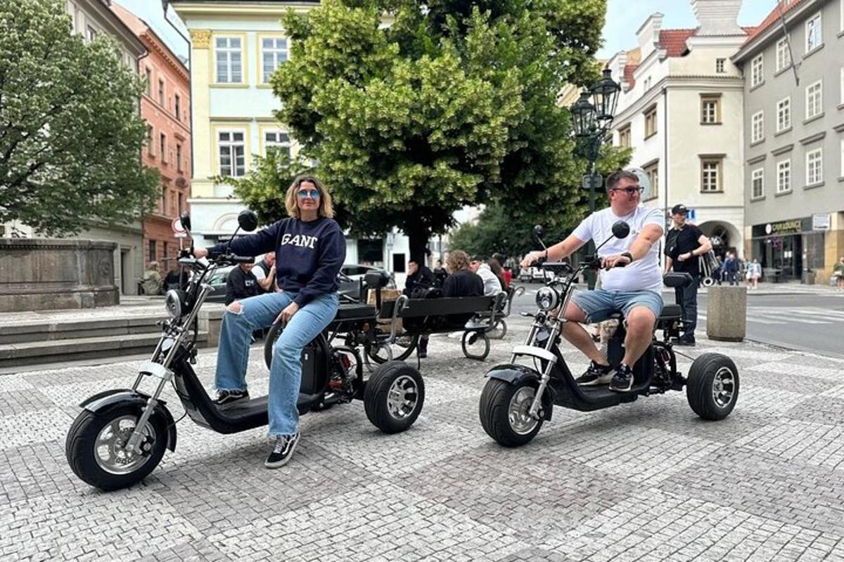 dva lidé jedoucí na koloběžkách na městské ulici