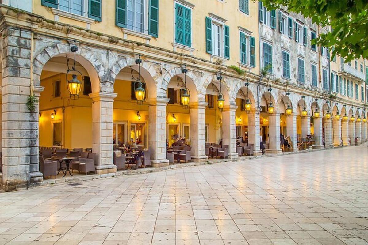 a building with arches and tables on a street