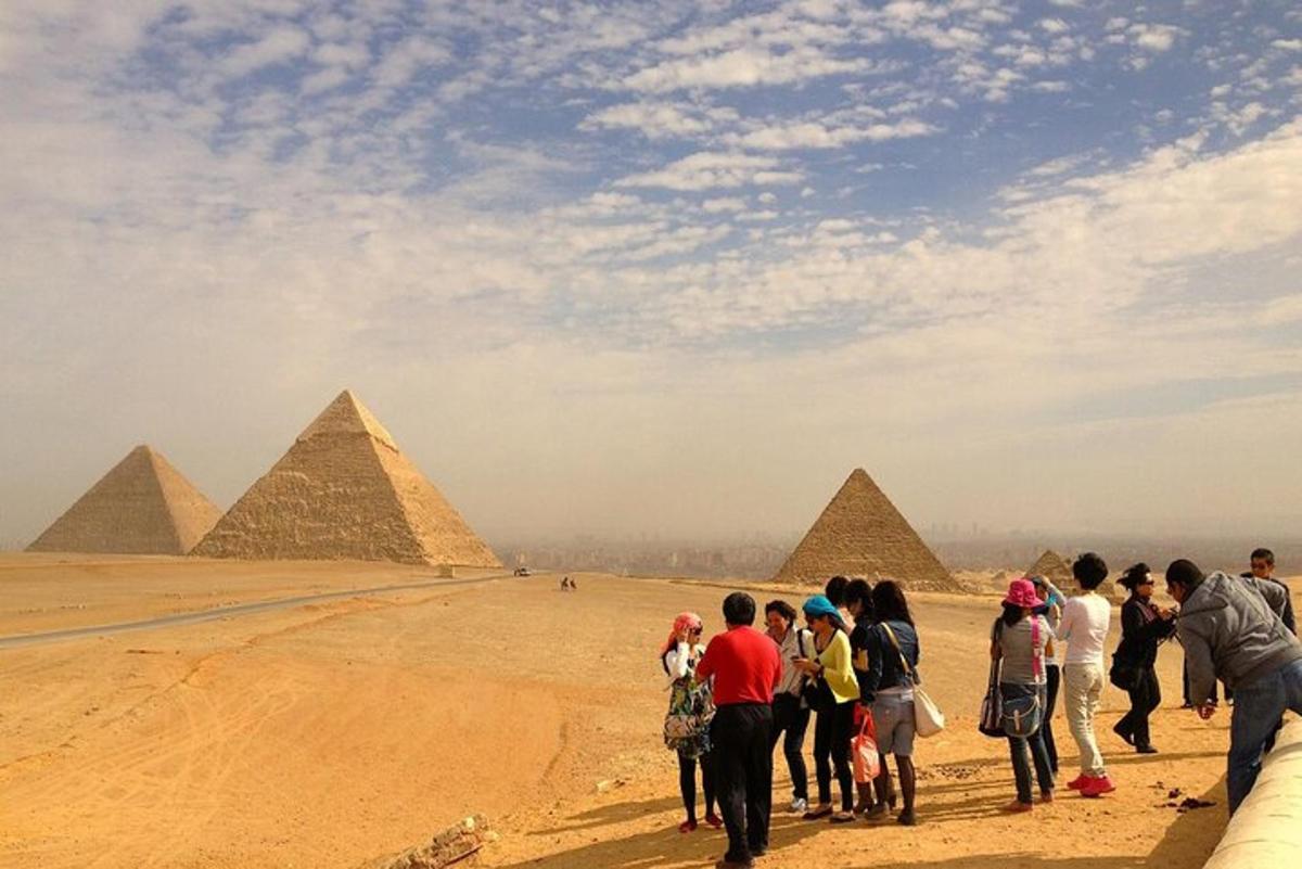 eine Gruppe von Menschen steht vor den Pyramiden
