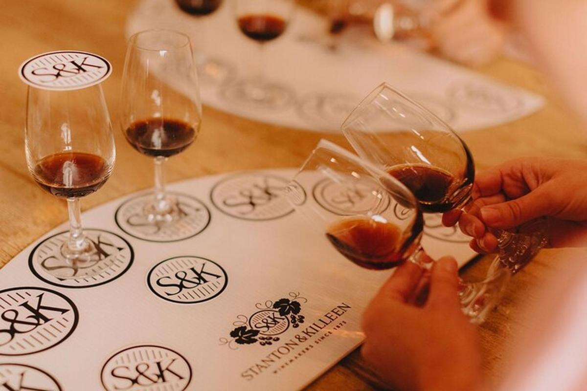 um grupo de pessoas segurando taças de vinho sobre uma mesa