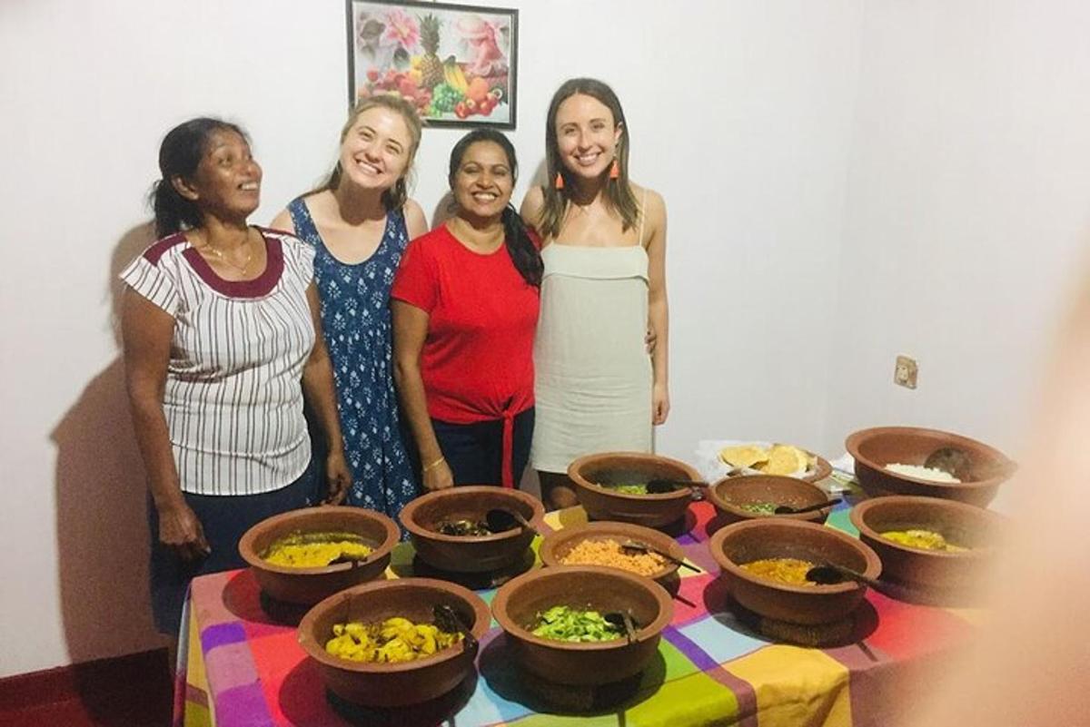 a group of women standing next to a table with bowls of food