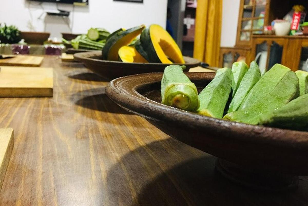 a bowl of green vegetables on a wooden table