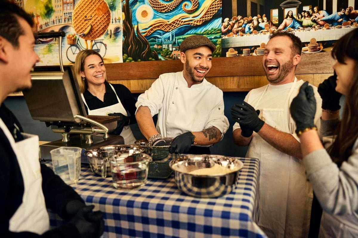 a group of people standing around a table in a restaurant